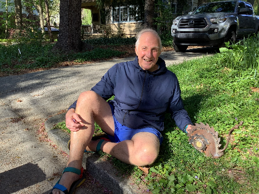 Victor Mair sitting on the grass with a baseball glove