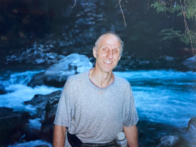 Victor Mair beside a river